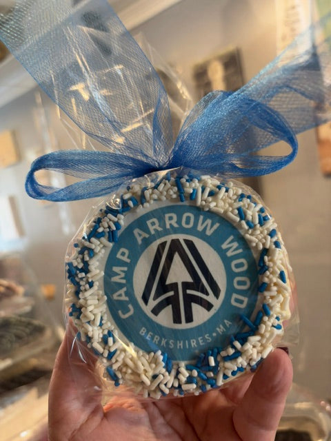 Rice Krispy Cake with camp logo wrapped in cellophane with a bow