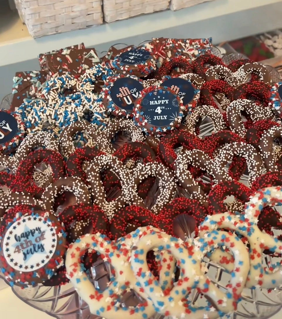 Tray with Red white and blue pretzels and oreos that say happy 4th of july