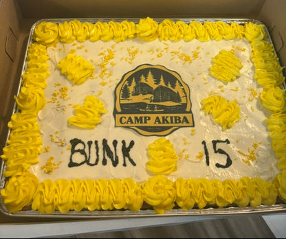 Cookie Cake with yellow and white frosting and camp logo