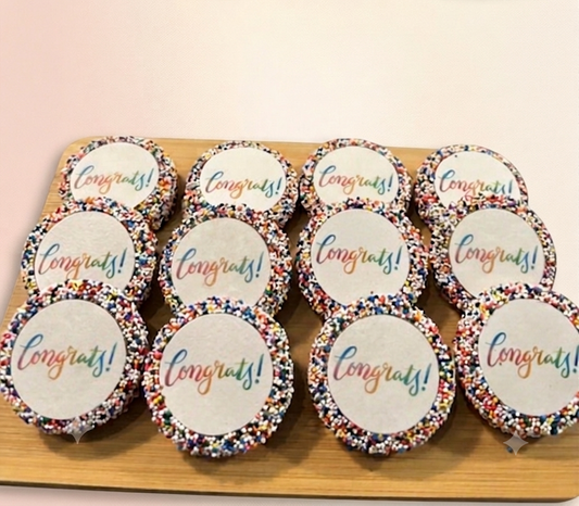 A tray of chocolate dipped oreos with a congrats message